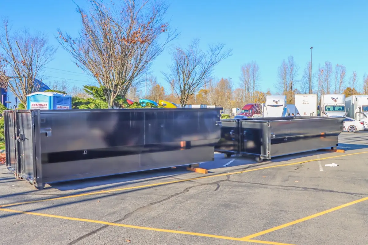 Professional dumpster rental service with roll-off container on residential driveway in Millington